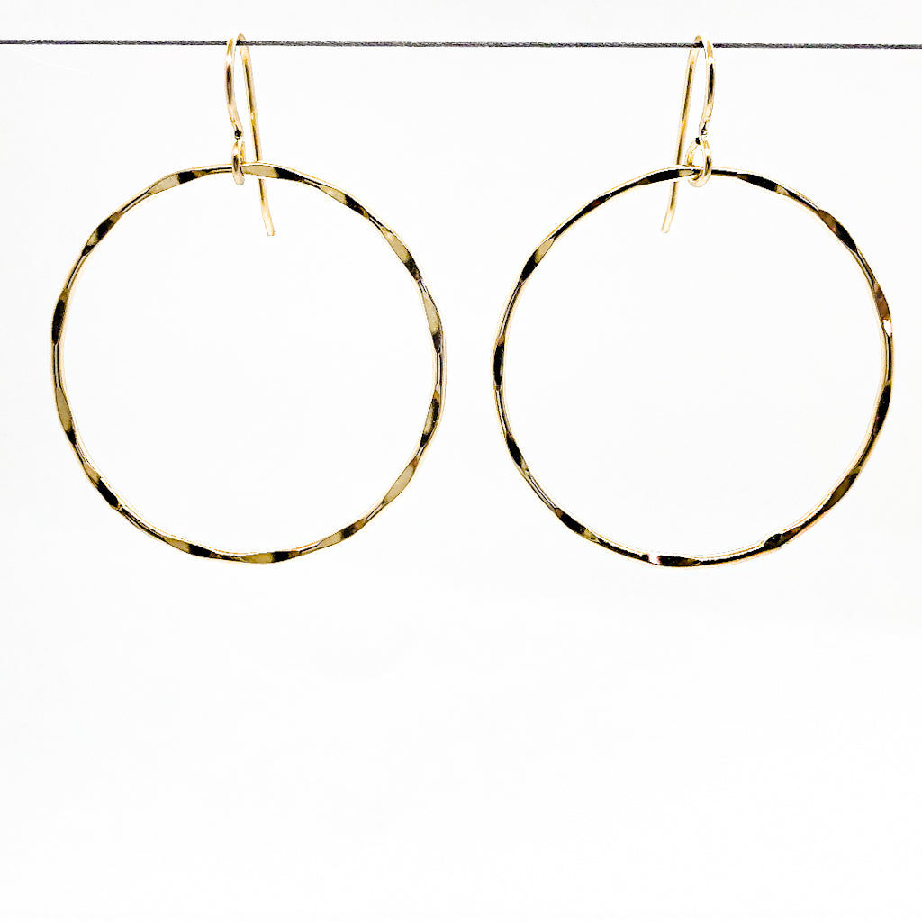 14k Gold Filled Large Orbit Earrings by Judie Raiford hanging on a wire