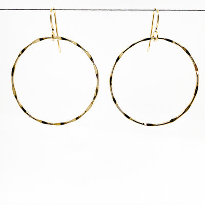 14k Gold Filled Large Orbit Earrings by Judie Raiford hanging on a wire