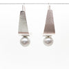 Sterling Tri Tuck Earrings with Gray Baroque Pearl by Judie Raiford hanging on a wire