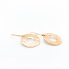 side angle view of 14k Gold Filled Ball Pein Donut Earrings on handmade wire by Judie Raiford