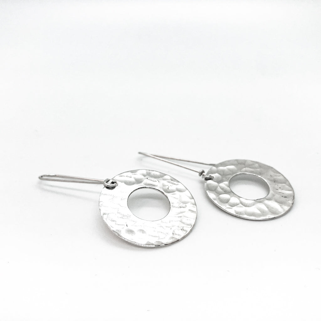 front side angle view of sterling silver Ball Pein Hammered Donut Earrings by Judie Raiford