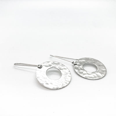 front side angle view of sterling silver Ball Pein Hammered Donut Earrings by Judie Raiford