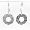 sterling silver Ball Pein Hammered Donut Earrings by Judie Raiford hanging on a wire