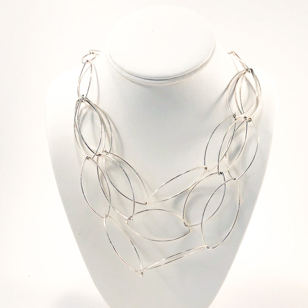 Sterling Triple Strand Baguette Necklace by Judie Raiford on white display bust