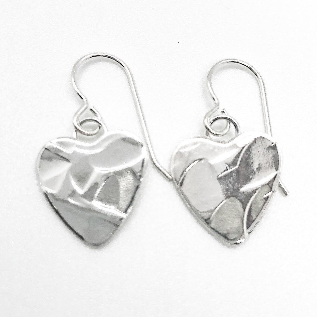 flat lay view of Sterling Silver Small Hammered Heart Earrings by Judie Raiford