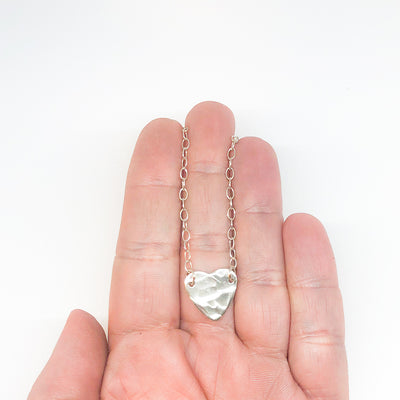 sterling silver Stationary Heart Layering Necklace by Judie Raiford held in hand