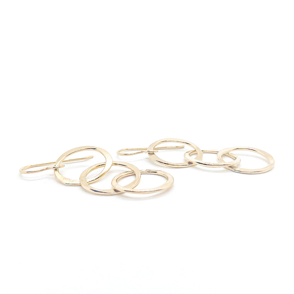 side angle lay of 14k Gold Filled Hammered Triple Circle Earrings by Judie Raiford