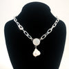 Sterling Irina Necklace with white coin pearl and white baroque pearl by Judie Raiford on black display bust