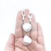 Sterling Irina Necklace with white coin pearl and white baroque pearl by Judie Raiford held in hand