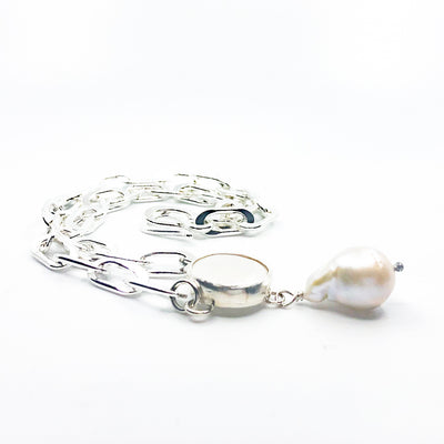 side angle view of Sterling Irina Necklace with white coin pearl and white baroque pearl by Judie Raiford