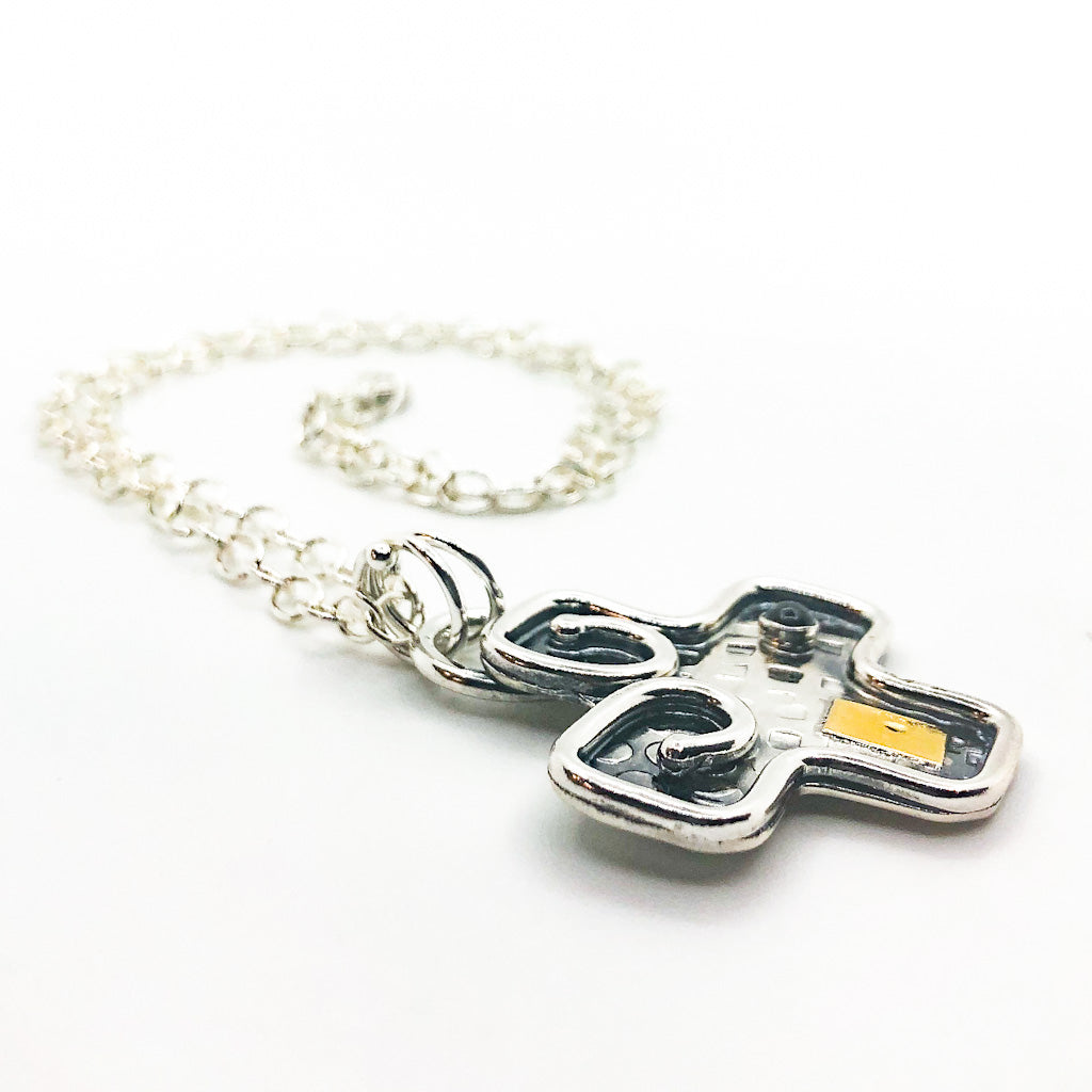 side angle view of Big Honker Cross Necklace by Judie Raiford