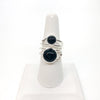 Sterling Wrap Ring with Black Onyx by Judie Raiford on white finger stand