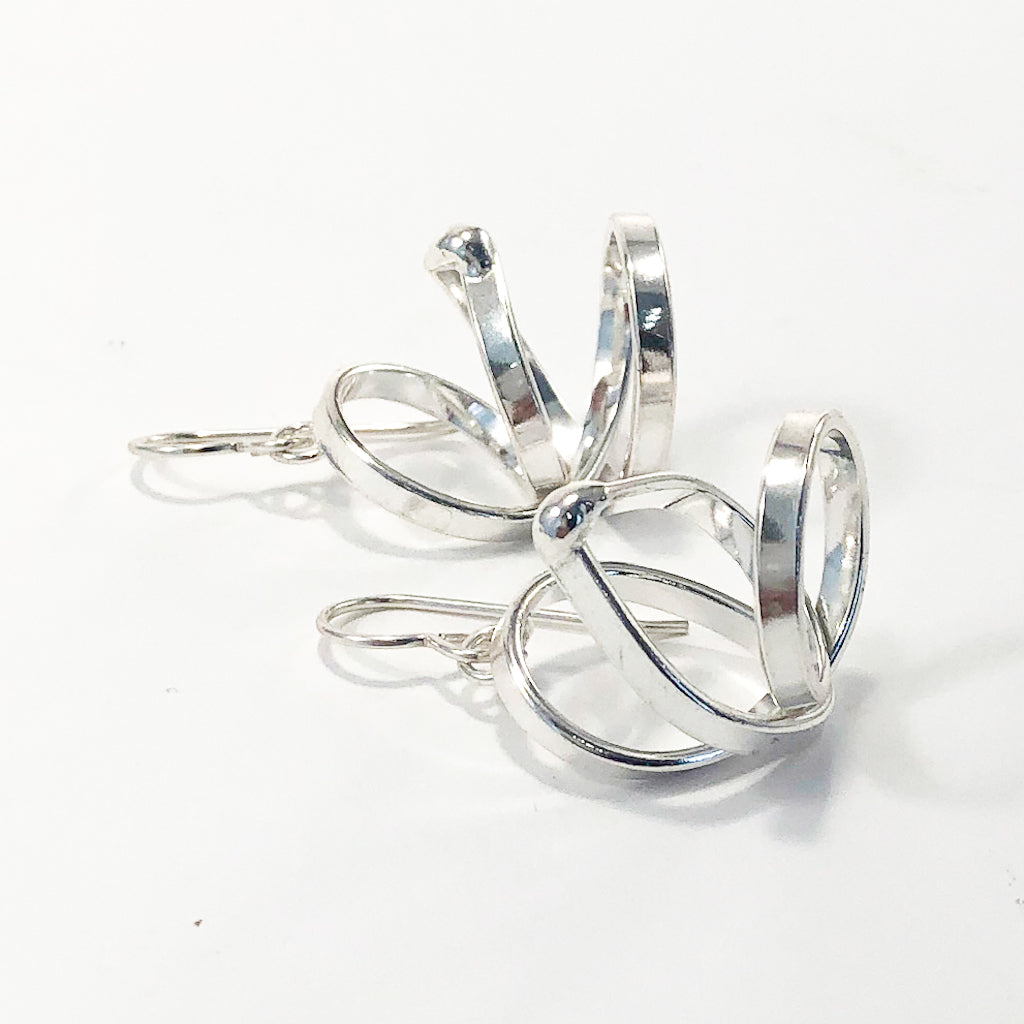 side view of Sterling Curly Girl Earrings by Judie Raiford