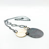 side angle view of Oxidized Sterling and 14k Gold Fill Hammered Circles Necklace by Judie Raiford