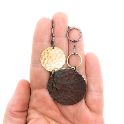 Oxidized Sterling and 14k Gold Fill Hammered Circles Necklace by Judie Raiford held in hand