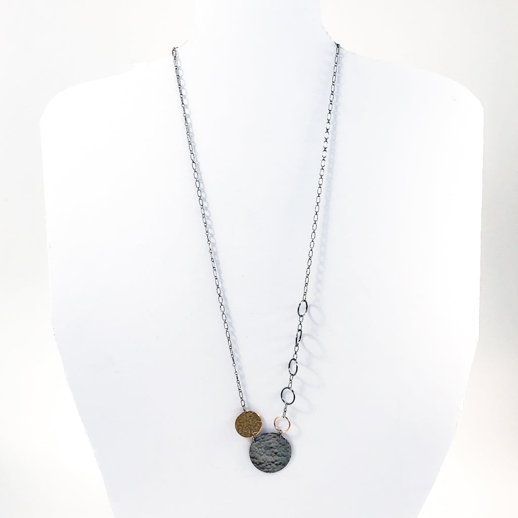 Oxidized Sterling and 14k Gold Fill Hammered Circles Necklace by Judie Raiford displayed on white mannequin bust