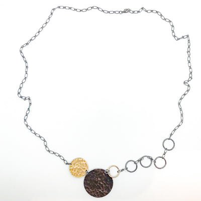 flat lay view of Oxidized Sterling and 14k Gold Fill Hammered Circles Necklace by Judie Raiford