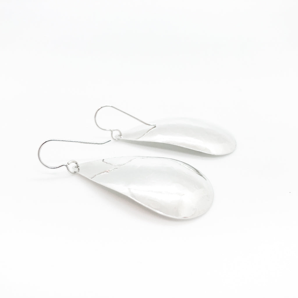 back side angle view of sterling silver Sinclastic Pear Shaped Earrings by Judie Raiford