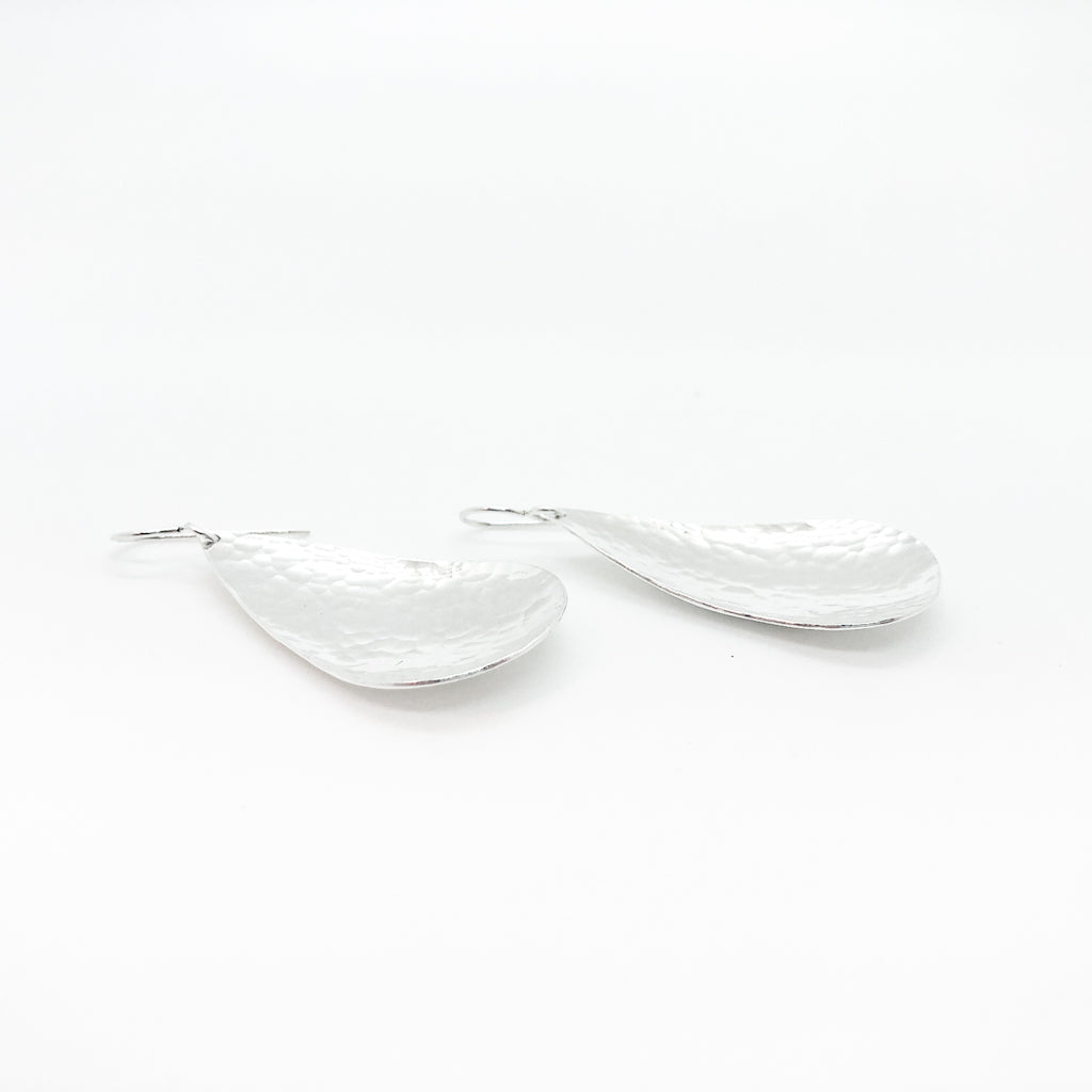 side angle view of sterling silver Sinclastic Pear Shaped Earrings by Judie Raiford
