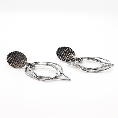 side angle view of Oxidized Sterling Silver Oval Top with 3 Dangles Earrings by Judie Raiford