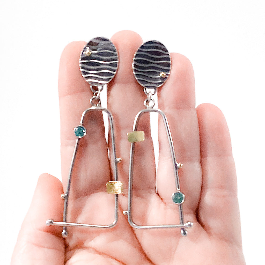 Sterling, 22k, 14k Four Score Earrings with Apatite by Judie Raiford held in hand