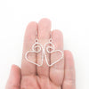 Sterling Silver Small Curly Jane Heart Textured Earrings by Judie Raiford held in hand