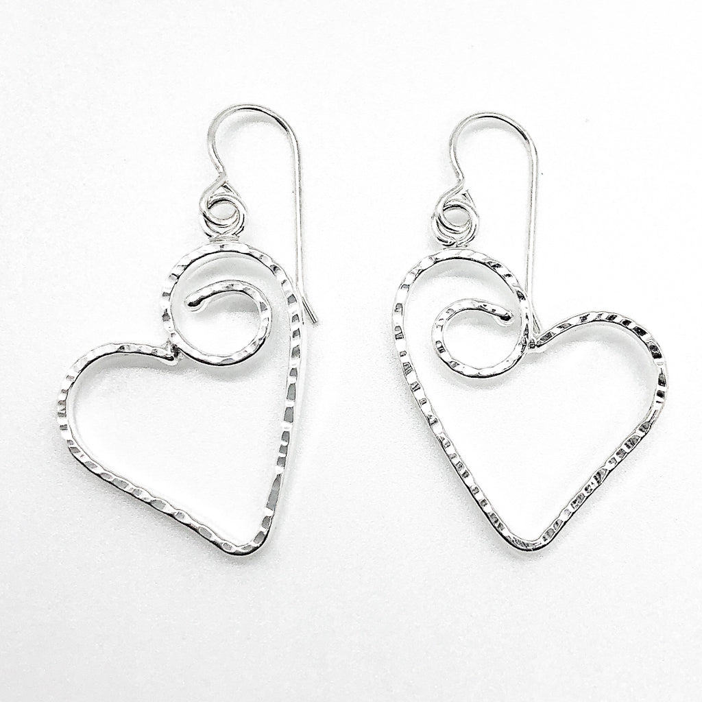 flat lay view of Sterling Silver Small Curly Jane Heart Textured Earrings by Judie Raiford