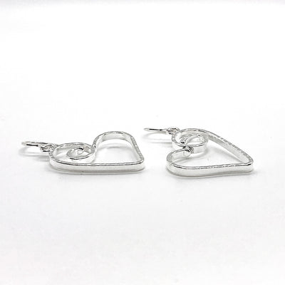 side angle view of Sterling Silver Small Curly Jane Heart Textured Earrings by Judie Raiford