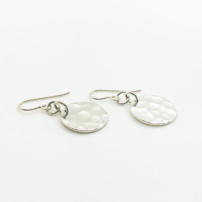 side angle view of Sterling Flat Disc Ball Pein Earrings by Judie Raiford
