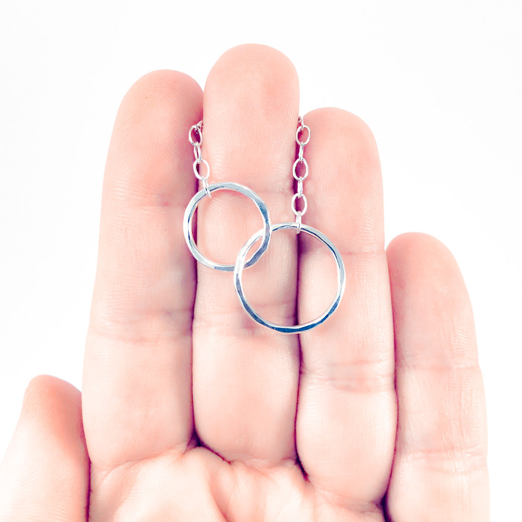 Sterling silver Maggie Necklace by Judie Raiford held in hand