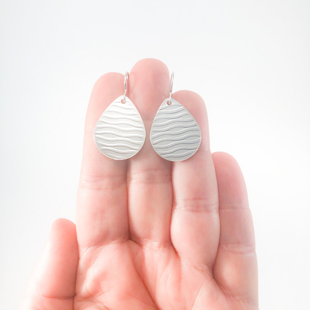 Sterling Aquapear Earrings by Judie Raiford held in hand