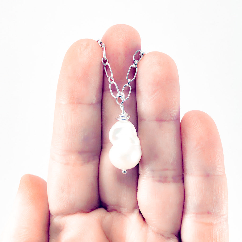 White Baroque Pearl on Sterling Long Short Chain by Judie Raiford held iin hand