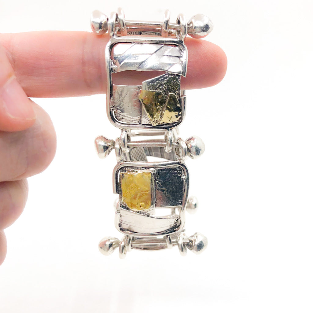 Sterling and 24k J Edgar Bracelet by Judie Raiford hanging on finger