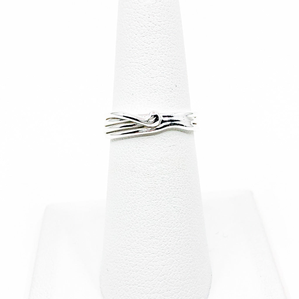 Sterling Random Theory Skinny Ring by Judie Raiford displayed on white ring display stand