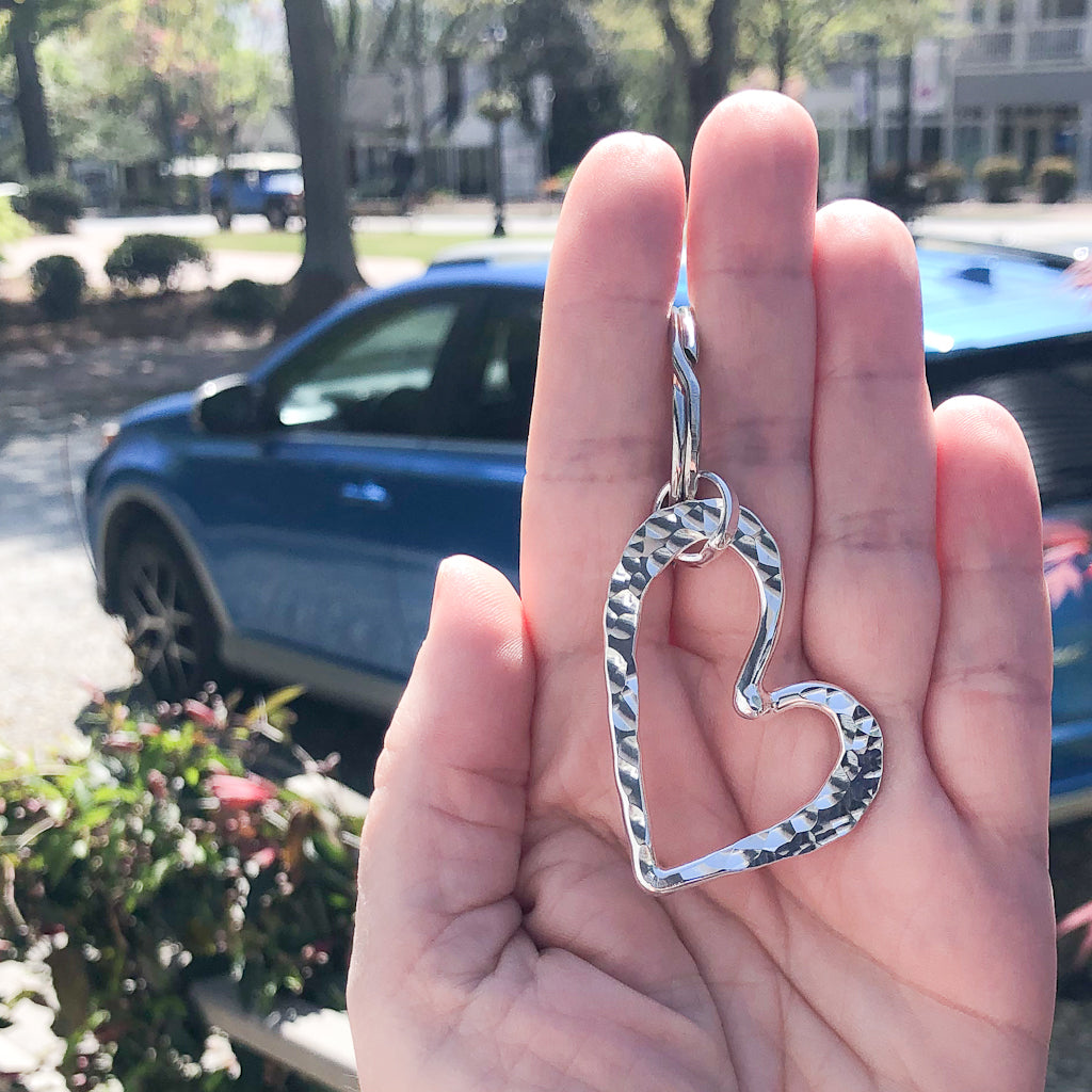 Sterling Heart Keyring by Judie Raiford held in hand in outdoor setting