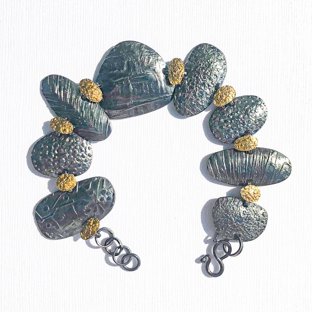 Pebble Bracelet in Oxidized Sterling and 22k Gold by Donna Burdic