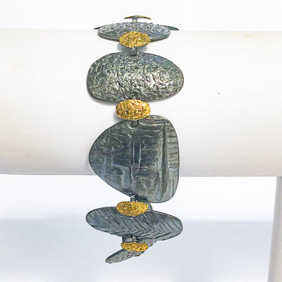 side view of Pebble Bracelet in Oxidized Sterling and 22k Gold by Donna Burdic