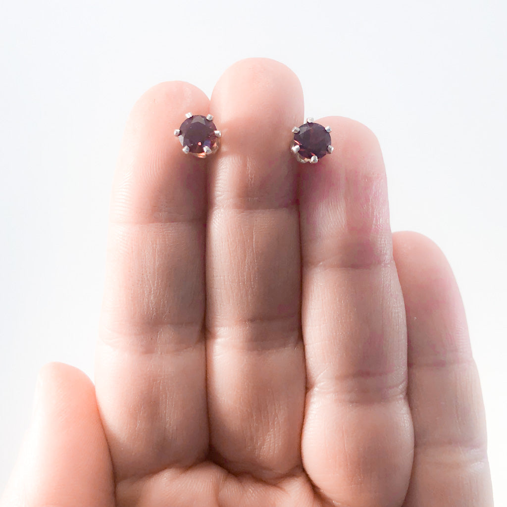 6mm Garnet Stud Earrings by Berlin Randall held in hand