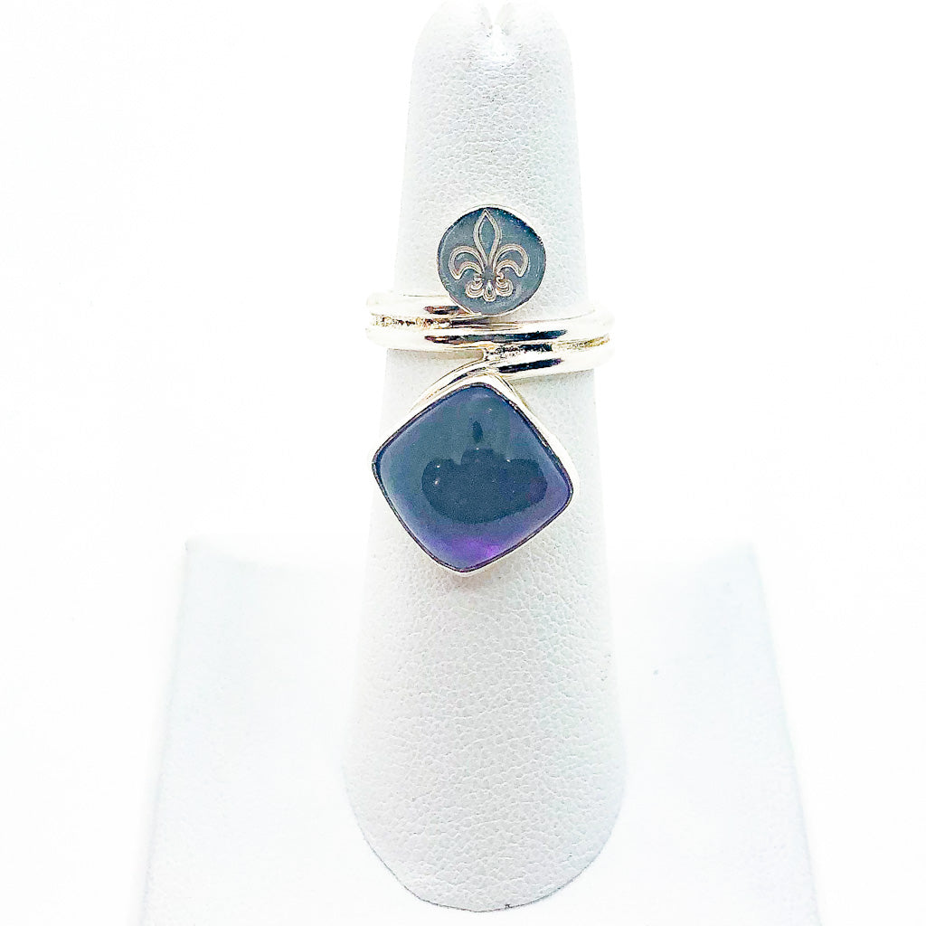 size 4.75 Sterling Wrap Ring with Amethyst and Fleur de Lis by Berlin Randall on white ring display stand