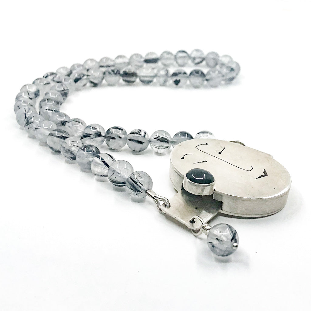 side angle view of Sterling Unmentionables Necklace with Onyx and Rutilated Quartz Tourmaline by Ling-Yen Jones