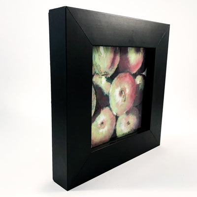 side angle view of pastel painting Apples in black wooden frame by Wanda Cox