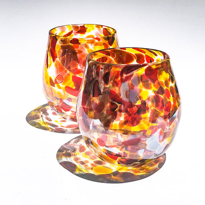 pair of Red, Gold & Silver Wine Tumblers by Nate Nardi on white background with colorful shadow reflecting