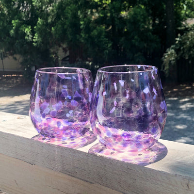a pair of Purple & Pink Speckled Wine Tumbler by Nate Nardi on deck rail