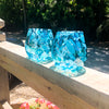 pair of Teal Speckled Wine Tumblers by Nate Nardi on wood hand rail in outdoor setting