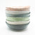 stack of multi colored small bowls by Nona Kelhofer